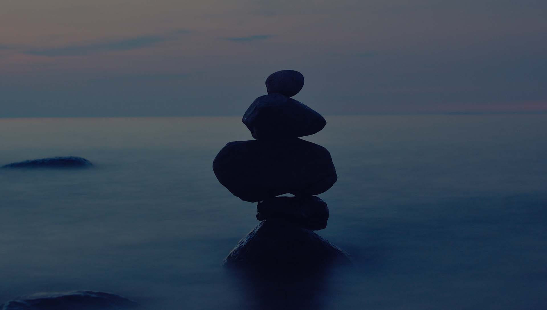balanced rocks on lake, carne, Paradise Float Spa for self care and balance